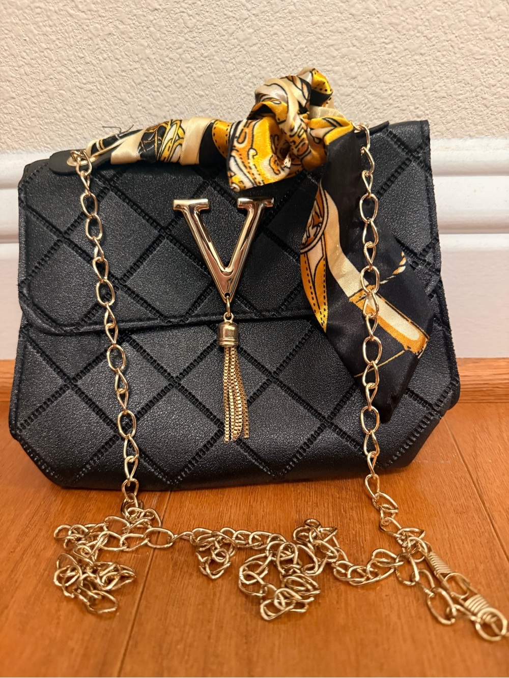 Elegant Black Quilted Crossbody Bag with Gold Chain and Scarf Accent